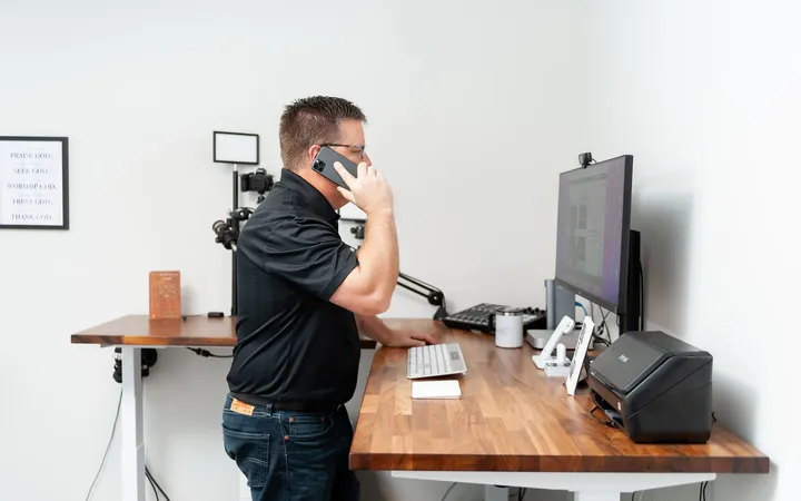Phil Cole taking a phone call at his desk