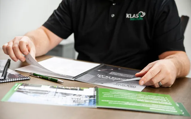 Phil Cole reviewing KLAS planning documents at a table